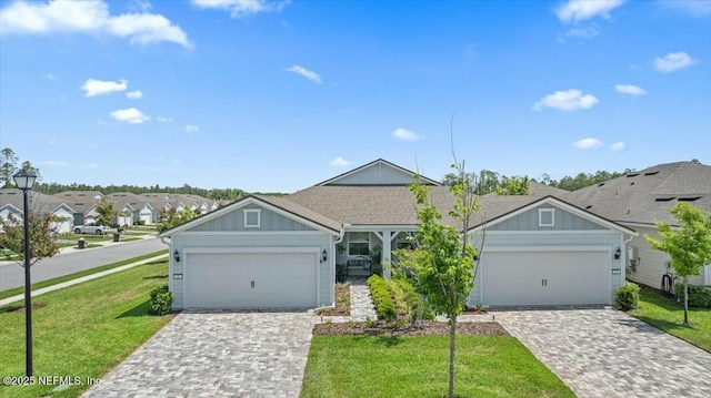 21 Yellow Iris Ct, Ponte Vedra, FL 32081 - view of front of home with board and batten siding, an attached garage, and a front yard