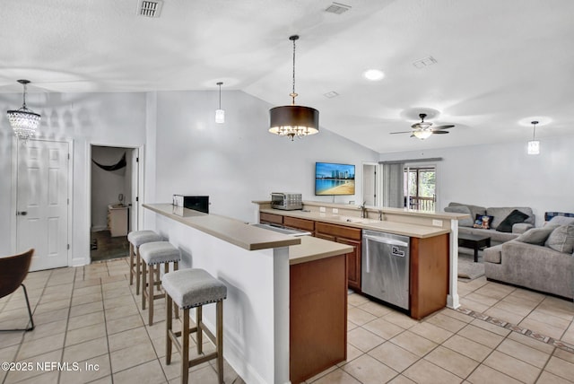 kitchen featuring stainless steel dishwasher, open floor plan, light tile patterned flooring, and vaulted ceiling