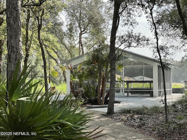 view of property exterior featuring a sunroom