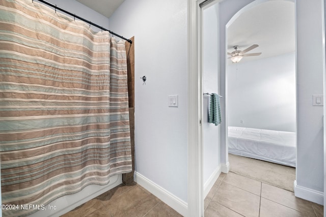 ensuite bathroom featuring baseboards, a ceiling fan, connected bathroom, and tile patterned floors