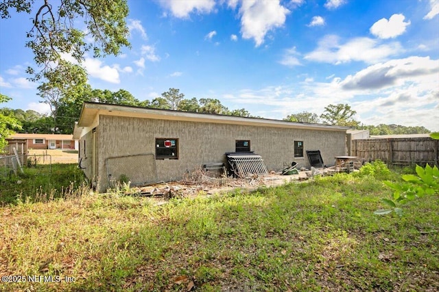 rear view of property with fence