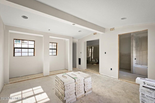 spare room featuring vaulted ceiling with beams