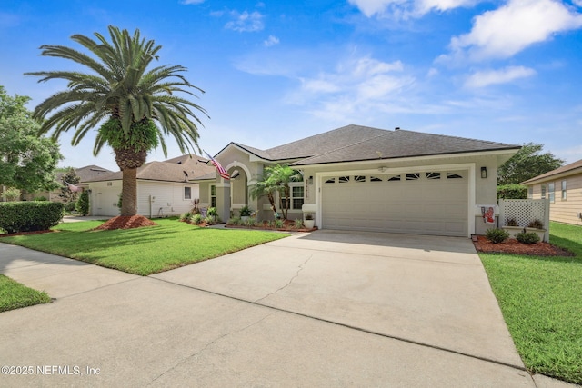 view of front facade featuring driveway, a front yard, a garage, a shingled roof, and stucco siding