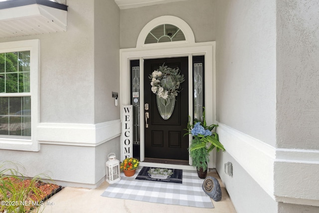 entrance to property with stucco siding