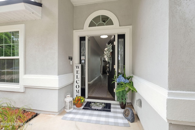 property entrance featuring stucco siding