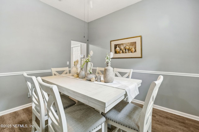 dining area featuring baseboards and wood finished floors