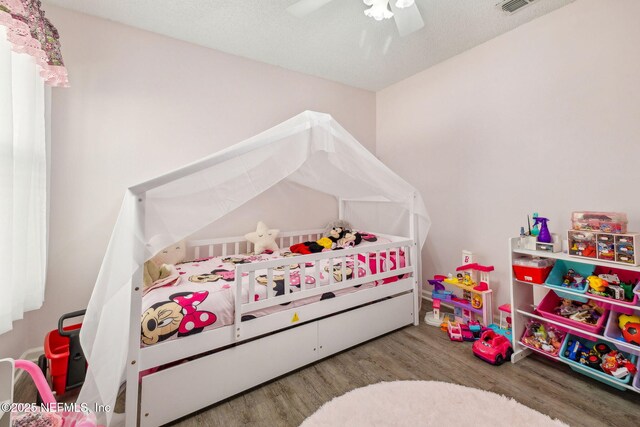 bedroom featuring a ceiling fan and wood finished floors