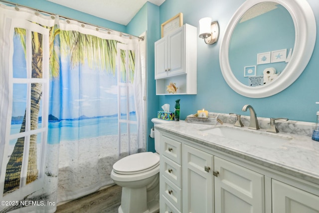 full bathroom with vanity, shower / bath combo with shower curtain, toilet, and wood finished floors