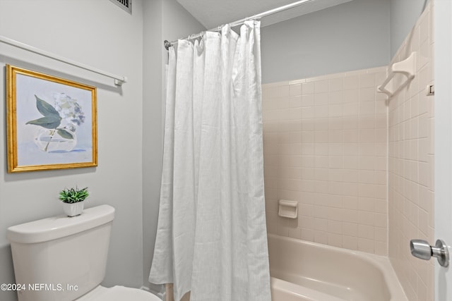 bathroom featuring toilet and shower / bathtub combination with curtain