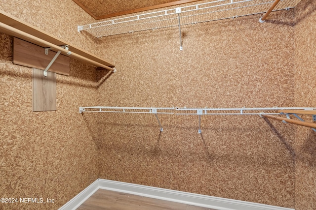 walk in closet featuring wood finished floors