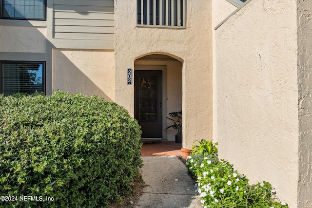 entrance to property featuring stucco siding