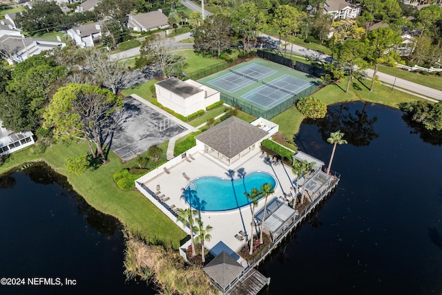 aerial view of a pool area and a large body of water