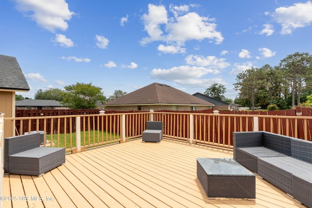 deck with an outdoor hangout area and a fenced backyard