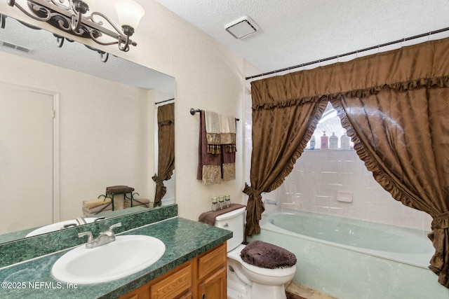 full bath with vanity, toilet, a textured ceiling, and visible vents