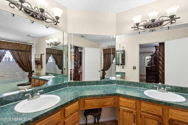 full bathroom with vanity, a textured ceiling, visible vents, and toilet