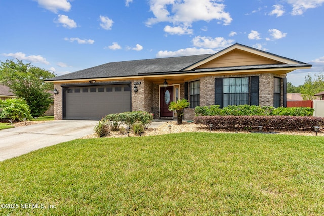 ranch-style home featuring brick siding, a garage, a front lawn, and concrete driveway