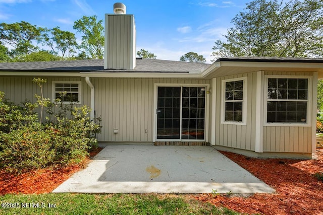 11598 Lazy Willow Ln, Jacksonville, FL 32223 - back of property featuring a patio area, a chimney, and roof with shingles