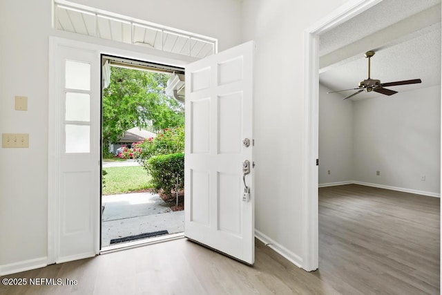 11598 Lazy Willow Ln, Jacksonville, FL 32223 - foyer entrance with wood finished floors, baseboards, and a ceiling fan