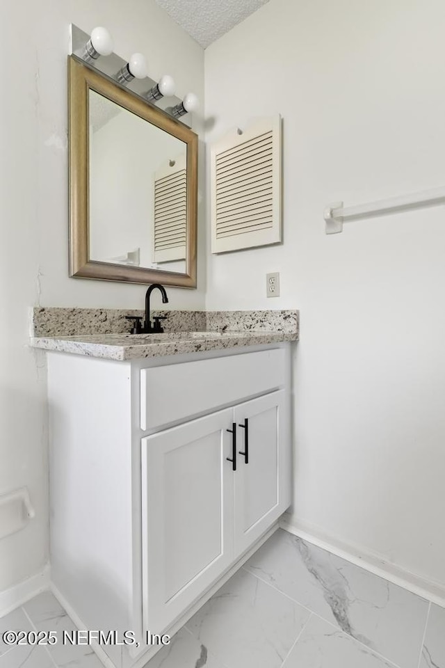 11598 Lazy Willow Ln, Jacksonville, FL 32223 - bathroom with marble finish floors, baseboards, vanity, and a textured ceiling