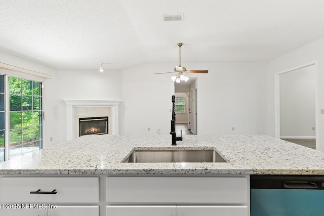 11598 Lazy Willow Ln, Jacksonville, FL 32223 - kitchen featuring dishwashing machine, a sink, open floor plan, and white cabinetry