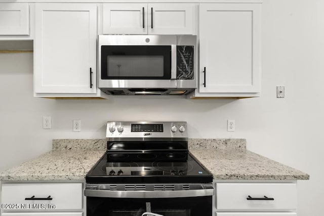 11598 Lazy Willow Ln, Jacksonville, FL 32223 - kitchen featuring appliances with stainless steel finishes, white cabinetry, and light stone counters