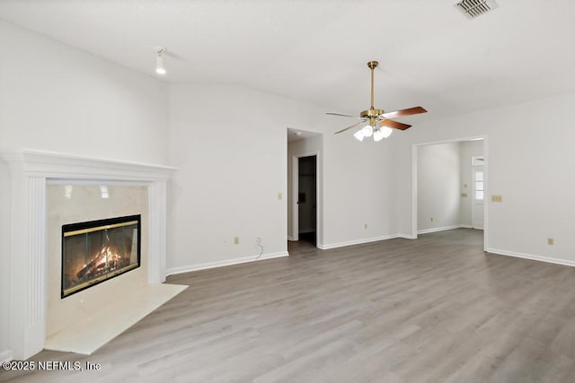 11598 Lazy Willow Ln, Jacksonville, FL 32223 - unfurnished living room featuring a premium fireplace, a ceiling fan, wood finished floors, lofted ceiling, and baseboards
