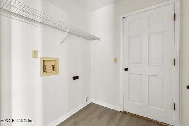 11598 Lazy Willow Ln, Jacksonville, FL 32223 - washroom featuring hookup for a washing machine, wood finished floors, electric dryer hookup, and baseboards