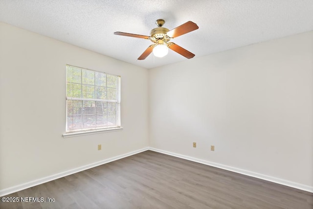 11598 Lazy Willow Ln, Jacksonville, FL 32223 - spare room featuring dark wood-type flooring, baseboards, ceiling fan, and a textured ceiling