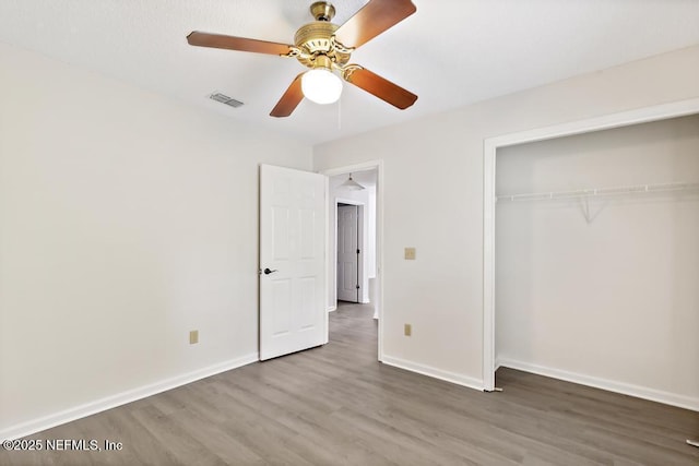 11598 Lazy Willow Ln, Jacksonville, FL 32223 - unfurnished bedroom featuring wood finished floors, a closet, baseboards, and ceiling fan