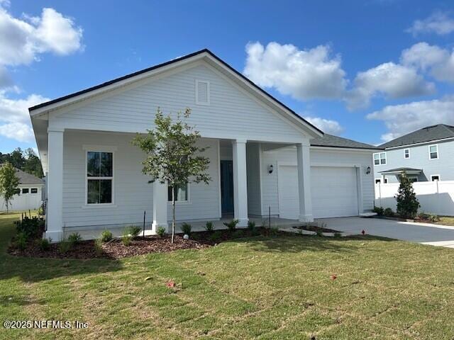 ranch-style home with an attached garage, a front lawn, covered porch, and concrete driveway