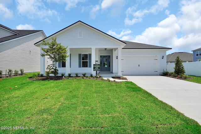 440 Slash Pine Pl, Yulee, FL 32097 - single story home featuring concrete driveway, a garage, and covered porch