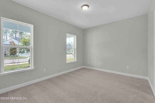 440 Slash Pine Pl, Yulee, FL 32097 - spare room featuring plenty of natural light, light carpet, and baseboards