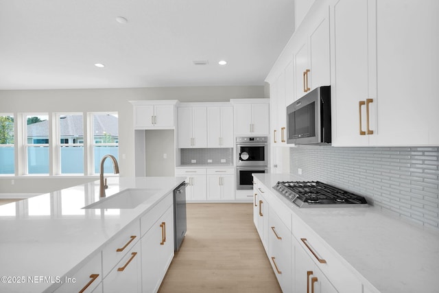 440 Slash Pine Pl, Yulee, FL 32097 - kitchen with a sink, appliances with stainless steel finishes, healthy amount of natural light, white cabinetry, and recessed lighting