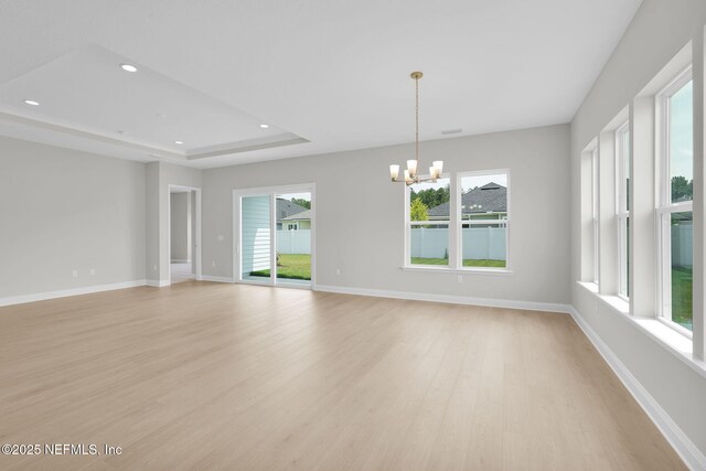440 Slash Pine Pl, Yulee, FL 32097 - spare room featuring light wood-style floors, a chandelier, recessed lighting, baseboards, and a raised ceiling