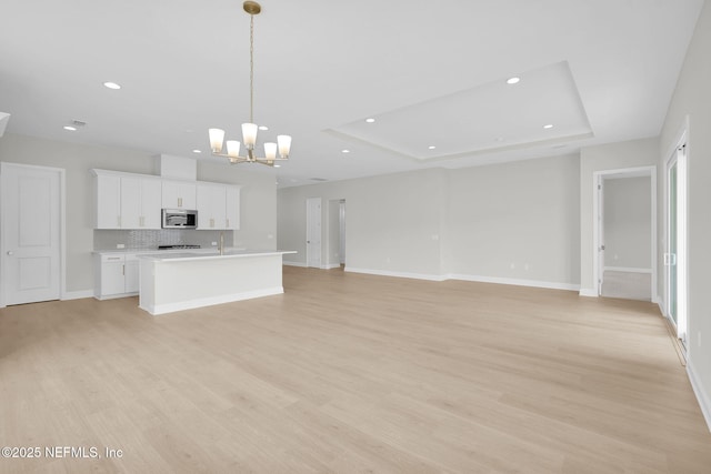 440 Slash Pine Pl, Yulee, FL 32097 - unfurnished living room featuring a chandelier, light wood-style floors, recessed lighting, and baseboards