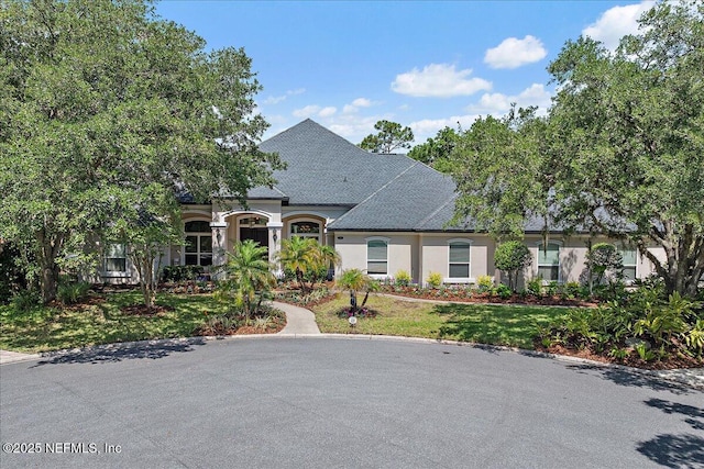 408 Osprey Lookout Ct Unit 29, Ponte Vedra Beach, FL 32082 - french country home featuring stucco siding, a front yard, and roof with shingles