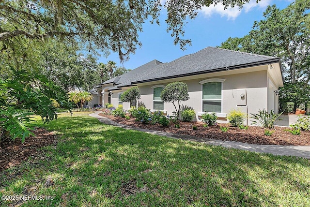 408 Osprey Lookout Ct Unit 29, Ponte Vedra Beach, FL 32082 - view of home's exterior featuring stucco siding, a yard, and a shingled roof