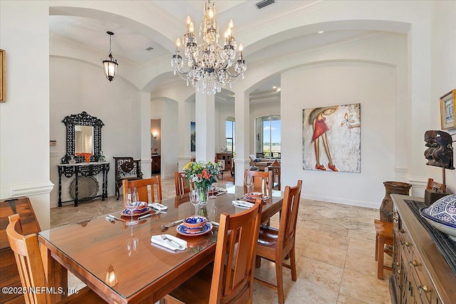 408 Osprey Lookout Ct Unit 29, Ponte Vedra Beach, FL 32082 - dining space with crown molding, arched walkways, a chandelier, stone tile floors, and baseboards