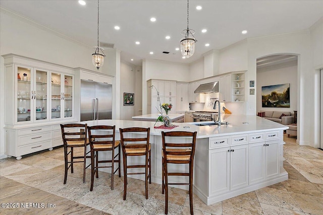 408 Osprey Lookout Ct Unit 29, Ponte Vedra Beach, FL 32082 - kitchen with built in refrigerator, extractor fan, ornamental molding, arched walkways, and light countertops