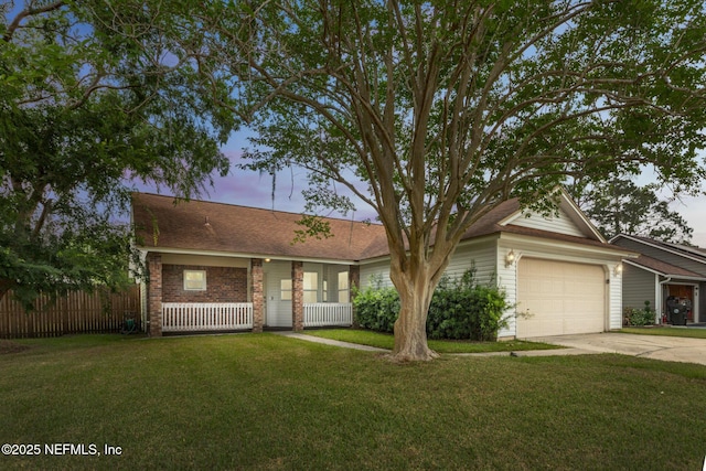 single story home with driveway, brick siding, fence, a garage, and a front yard