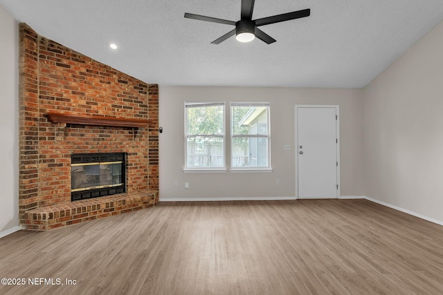 unfurnished living room featuring a textured ceiling, wood finished floors, and ceiling fan