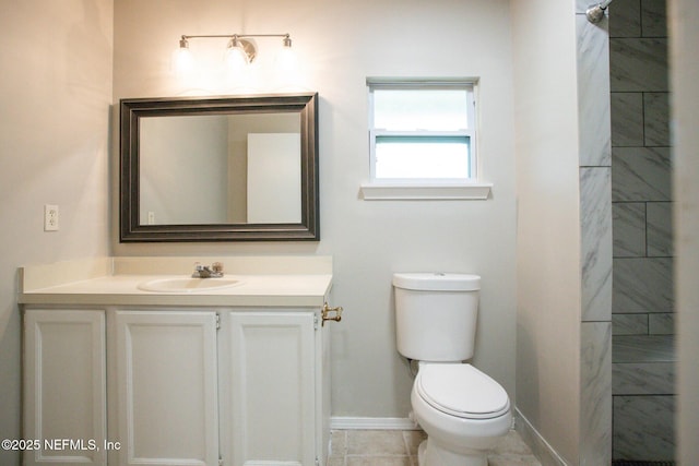 bathroom featuring toilet, baseboards, and vanity