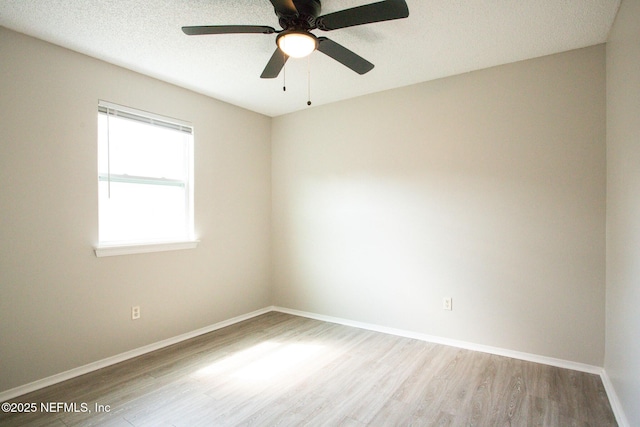 unfurnished room with baseboards, ceiling fan, and wood finished floors