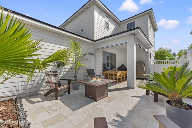 109 Redbud Ln, Yulee, FL 32097 - back of property featuring fence, a patio, and a fire pit