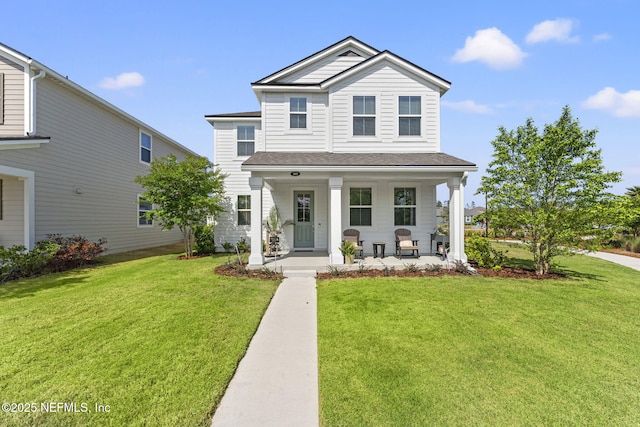 109 Redbud Ln, Yulee, FL 32097 - traditional-style home featuring roof with shingles, covered porch, and a front yard