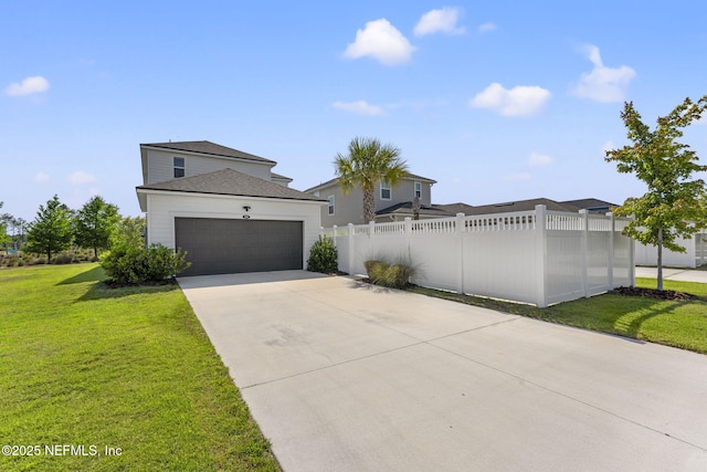 109 Redbud Ln, Yulee, FL 32097 - view of front of home featuring fence, concrete driveway, a garage, and a front yard