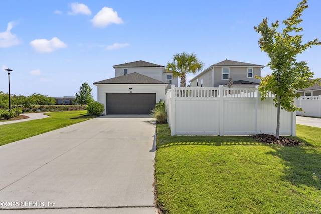 109 Redbud Ln, Yulee, FL 32097 - view of front of house featuring concrete driveway, an attached garage, fence, and a front lawn