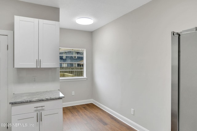 2578 Haldumar Ter, Jacksonville, FL 32204 - unfurnished dining area featuring baseboards and wood finished floors