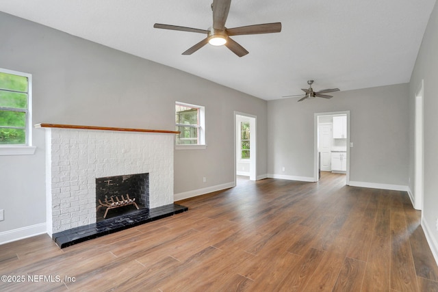 2578 Haldumar Ter, Jacksonville, FL 32204 - unfurnished living room featuring a ceiling fan, a brick fireplace, and wood finished floors