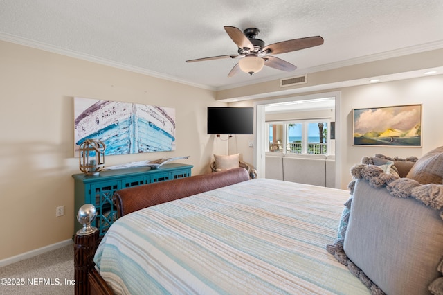 bedroom with a textured ceiling, carpet, baseboards, visible vents, and ornamental molding